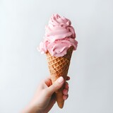 Hand holding pink ice cream in a cone plate isolated on white background