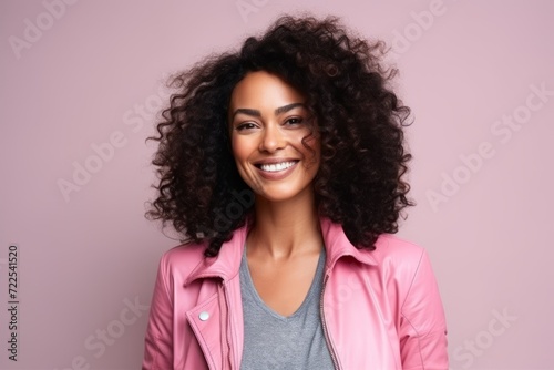 Portrait of a smiling african american woman in pink jacket