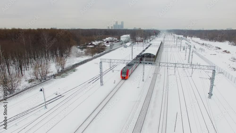 Passengers train Lastochka rides from station and cityscape Passengers train Lastochka rides from station and cityscape