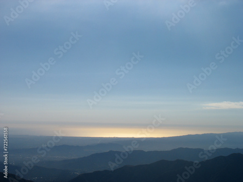 View of sunset in the San Gabriel Mountains of Los Angeles County, California. Strawberry Peak trail. Beautiful sky and range landscape panorama.