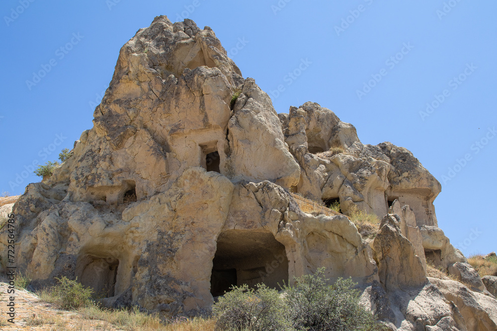 Ancient cave dwellings in Cappadocia's rugged landscape, ideal for educational content, historical documentaries, or travel and culture-themed projects.