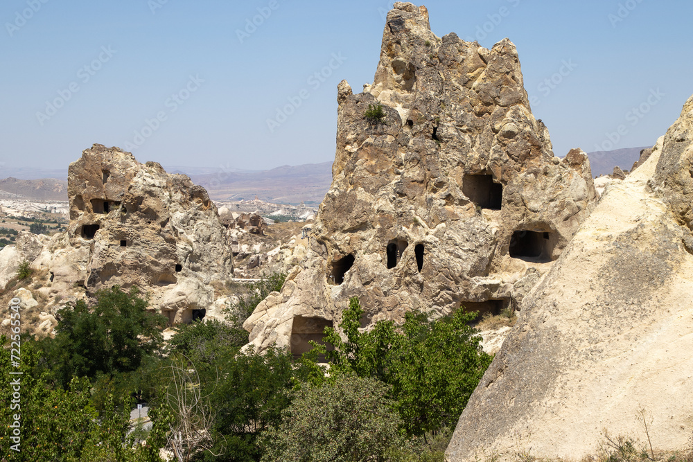 This captivating image of Cappadocia’s unique rock formations, with clear signs of ancient habitation, is perfect for educational materials, travel guides, historical publications, and documentaries.