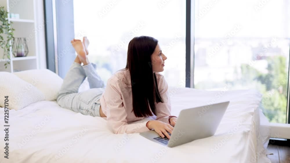 Attractive woman working remotely from home, typing on modern wireless laptop. Attractive woman working remotely from home, typing on modern wireless laptop.