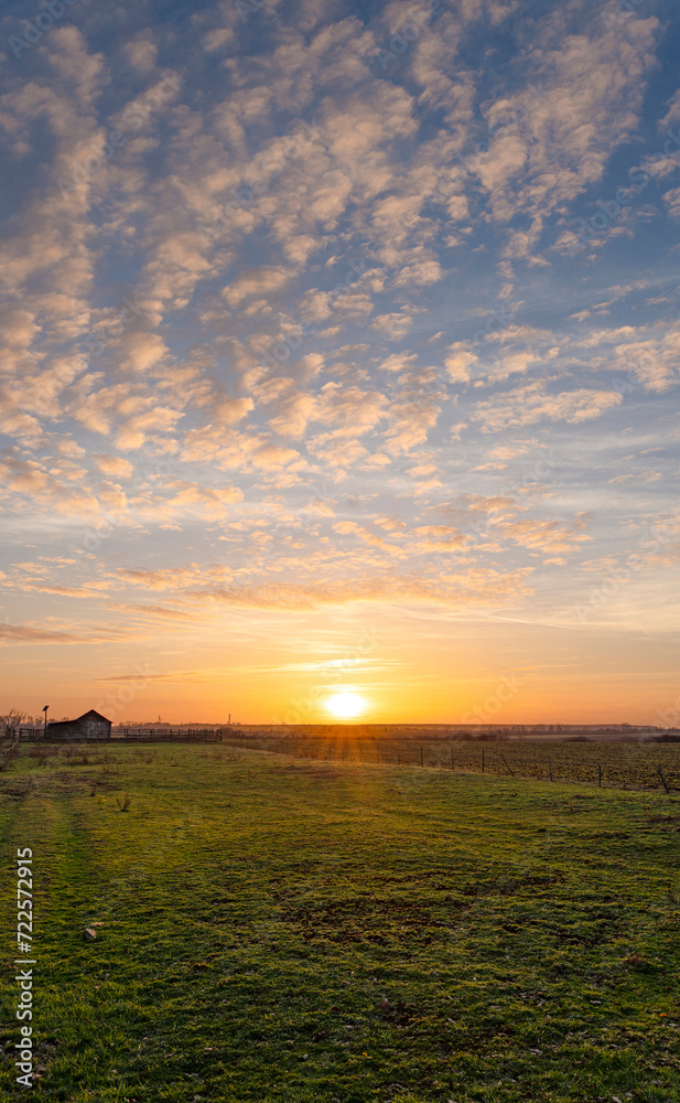 Beautiful landscape with sunset and colorful sky over the field Beautiful landscape with sunset and colorful sky over the field