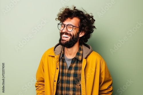 Portrait of a handsome hipster man with curly hair and glasses