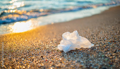 Sunny beach view marred by plastic waste, waves depositing debris on the shore, highlighting environmental impact and urgent need for conservation