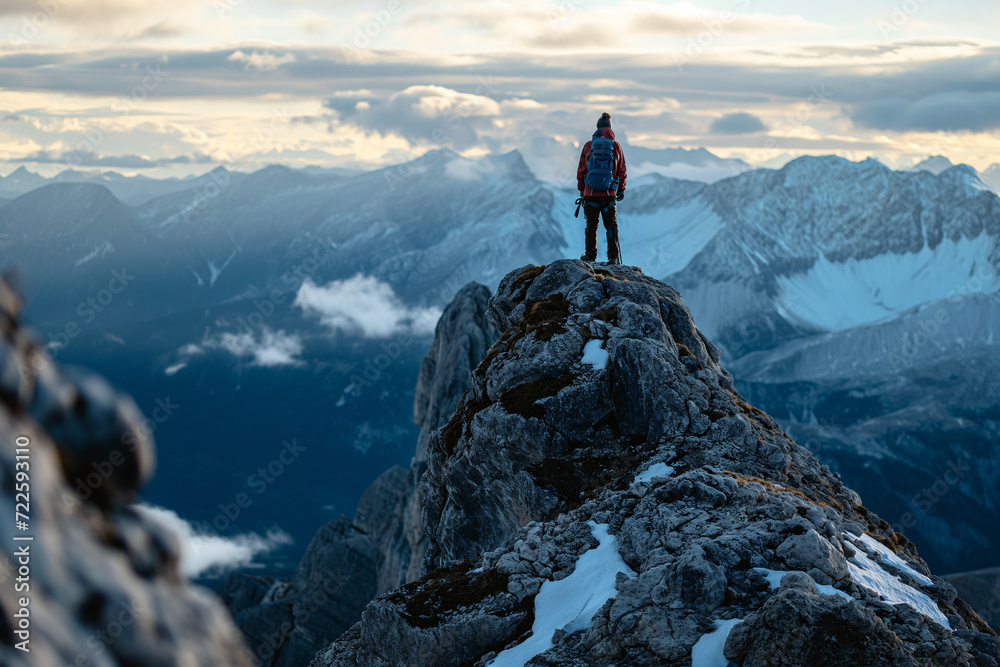 Person Standing on Snow-capped Mountain Peak