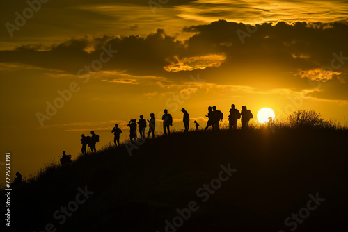 Group of People Standing on Hilltop  Overlooking Landscape
