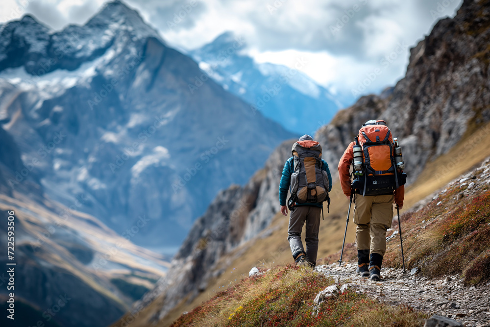 Two Hikers Ascending Hillside With Backpacks