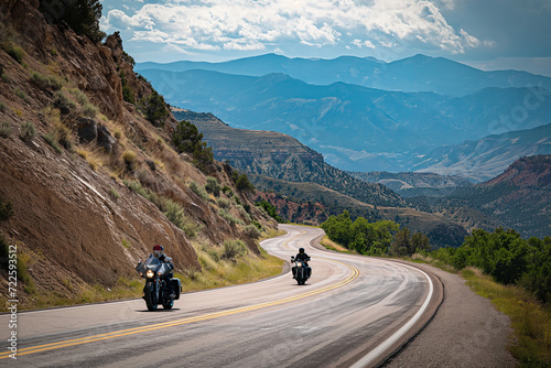 Two People Riding Motorcycles Down a Mountain Road