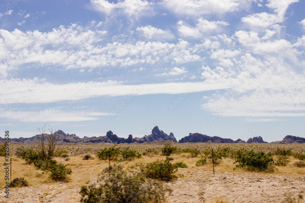 Beautiful blue sky with fluffy clouds over a desert with mountains in Arizona, USA. Panorama with high hills. Landscape on a sunny day Beautiful blue sky with fluffy clouds over a desert with mountains in Arizona, USA. Panorama with high hills. Landscape on a sunny day