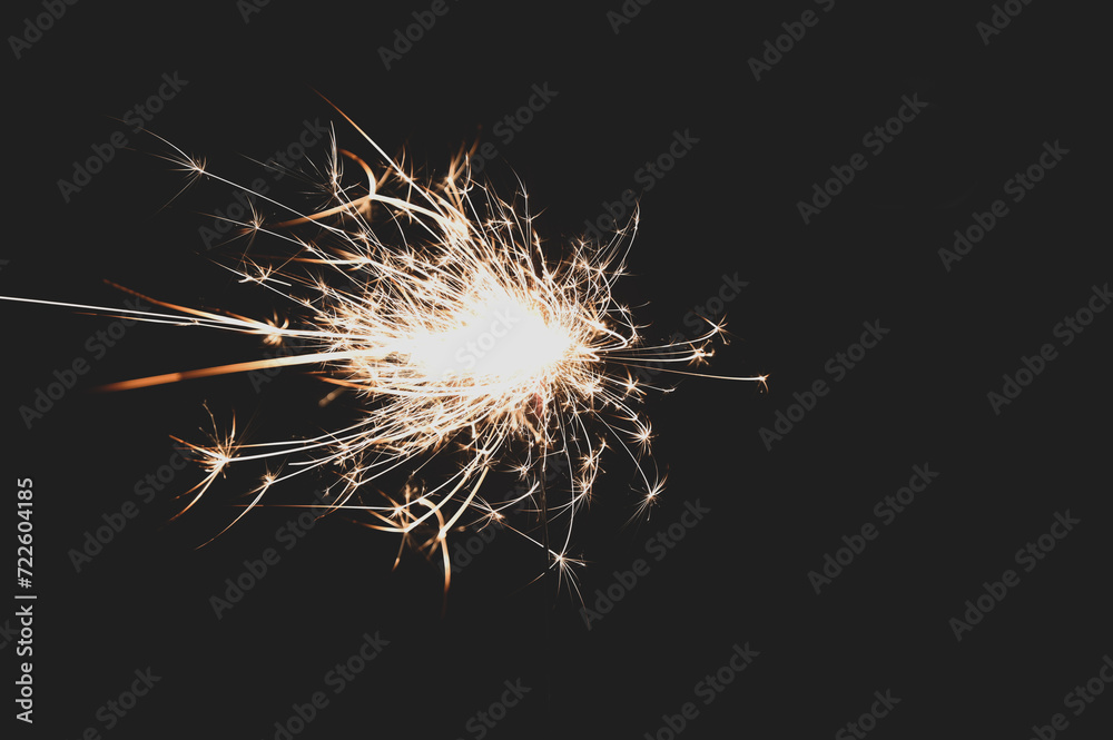 Burning sparklers on black background. New Year celebration. Burning Bengal fire.