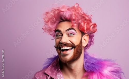 Joyful person with vibrant pink curly hair and beard, wearing shimmering purple jacket and feather boa, on lavender background, exuding happiness and eccentric fashion sense.