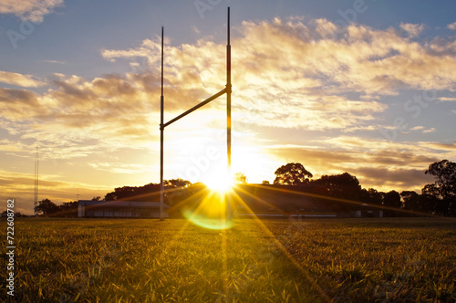 Goal posts for the sports of rugby league or rugby union football on the field at sunset  photo