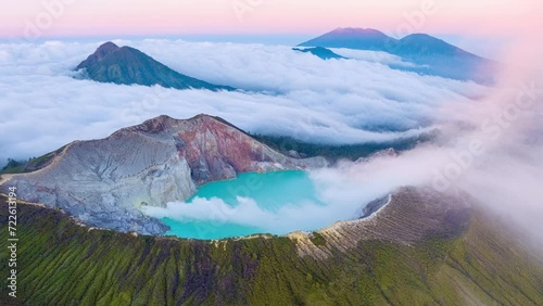 Aerial view Drone shot of fog at Kawah Ijen volcano with turquoise sulfur water lake and sunrise light.Amazing nature landscape view at East Java,Indonesia.Beautiful light Natural landscape background