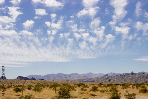 Photography Beautiful blue sky with fluffy clouds over a desert with mountains in Arizona, USA