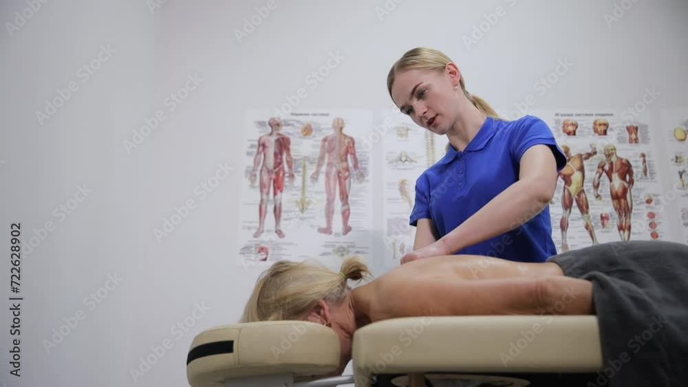 Adult woman relax during physiotherapy make massage, treatment back in clinic. SPA procedures, relaxing massage.