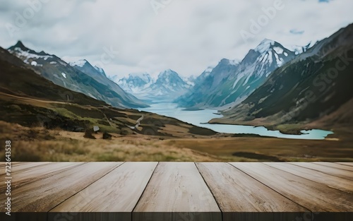 Empty wooden table with a blurred landscape in the background. © manuel