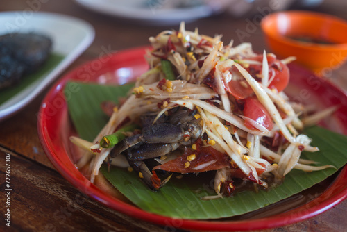 Papaya salad with crab, fermented fish. Thai papaya salad or what we call Somtum. The famous local Thai street food with hot and spicy photo