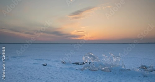 Sunset over a frozen lake in winter