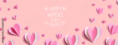Happy women's day message with pink paper hearts - flat lay