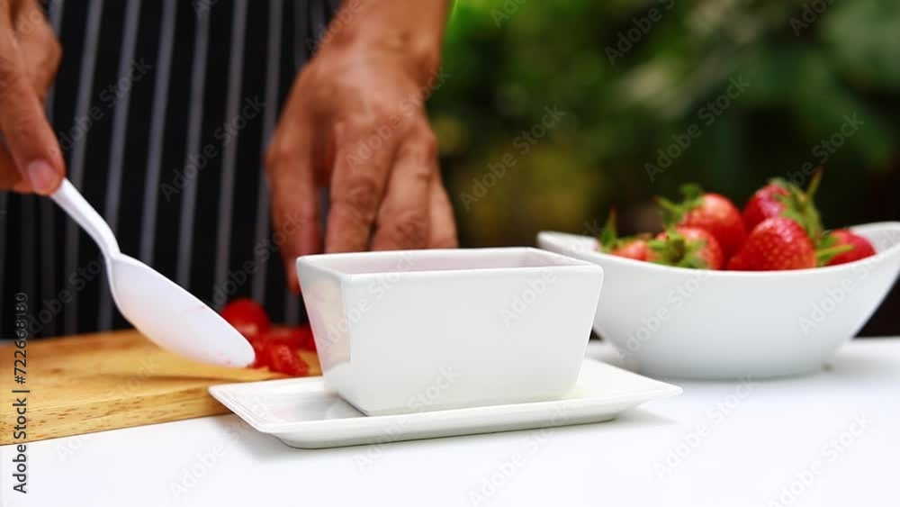 He was scooping ripe red strawberries and cutting them into pieces. into a bowl of fresh white strawberries
He was scooping ripe red strawberries and cutting them into pieces. into a bowl of fresh white strawberries