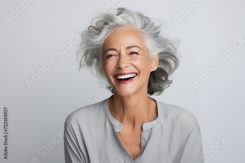 middle-aged woman in her 40s, with white gray hair, smiling beautifully as a skin care product model