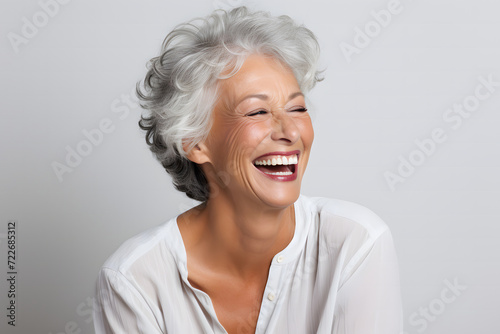middle-aged woman in her 40s, with white gray hair, smiling beautifully as a skin care product model © manof