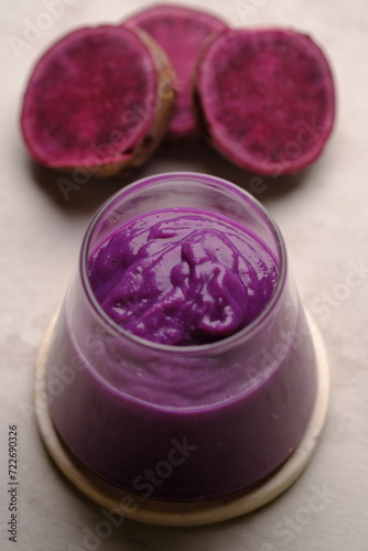 Ipomoea batatas. purple sweet potato smoothie in clear glass. a healthy diet containing lots of antioxidants and a source of carbohydrates.