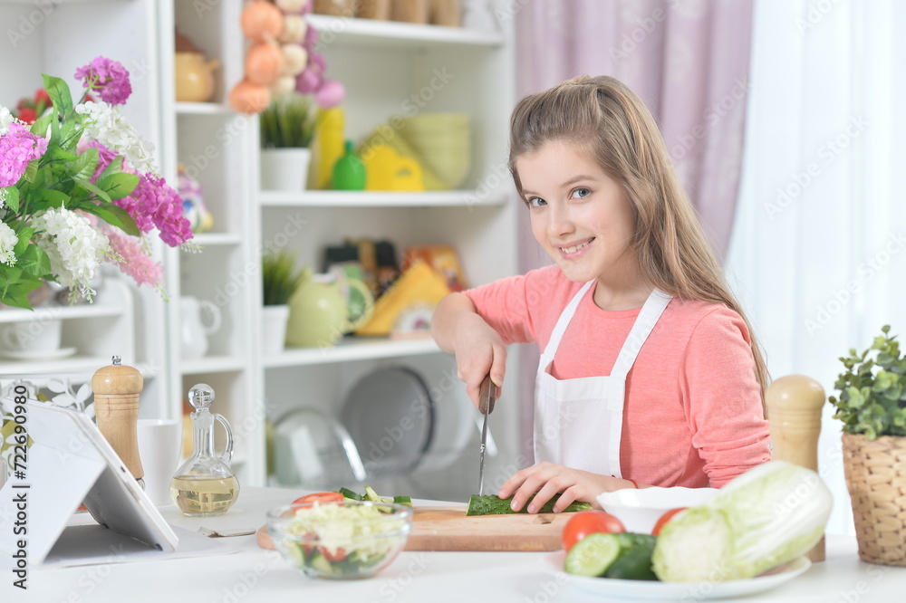 Portrait of young girl cooking in kitchen