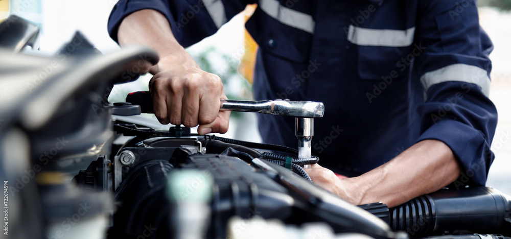 Mechanic are using the wrench to repair and maintenance auto engine at car repair shop,Car auto services and maintenance check concept. Mechanic are using the wrench to repair and maintenance auto engine at car repair shop,Car auto services and maintenance check concept.