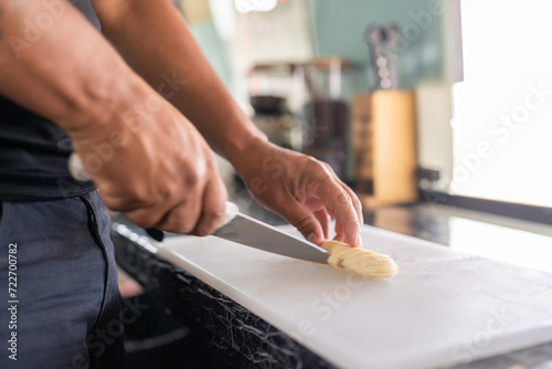 Man cutting banana in the counter of a food truck photo
