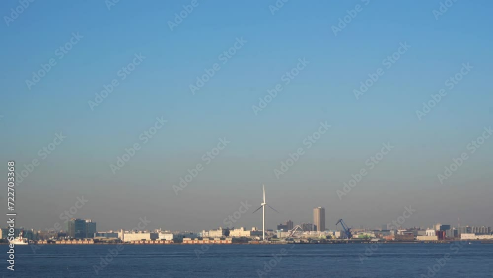 Yokohama cityscape with windmill seen over sea Yokohama cityscape with windmill seen over sea