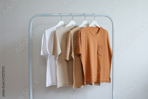 Collections of brown color t-shirts variant hanging on clothing rack in the shop