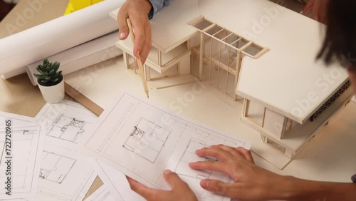 Interior designer drafting blueprint with customer supervise and oversee interior designer draw house room layout on home based on client demand. Architectural customer service. Burgeoning photo