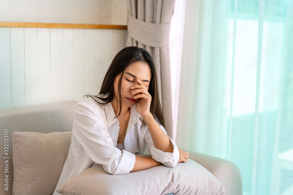 Lonely young Asian woman feeling depressed and stressed in living room at home, Negative emotion and mental health concept Lonely young Asian woman feeling depressed and stressed in living room at home, Negative emotion and mental health concept