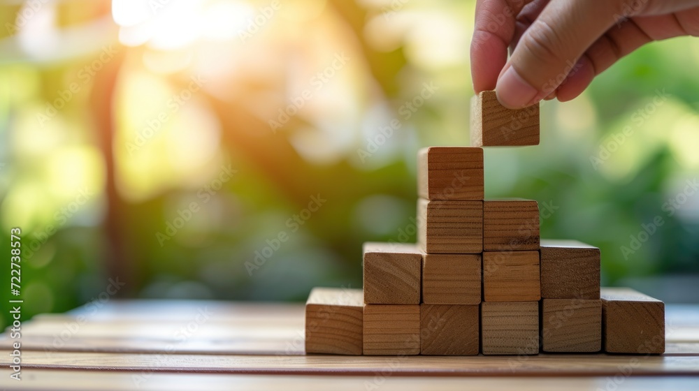 Hand aranging wood block stacking as step stair. Business concept for growth success process.