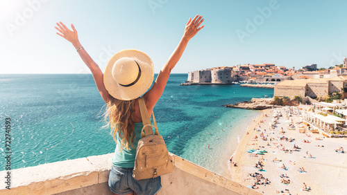Happy woman tourist enjoying view of the old town of Dubrovnik in Croatia photo