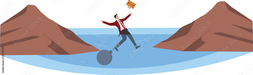 Businessman being trapped with ball and chain at the cliff