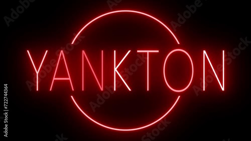 Flickering red retro style neon sign glowing against a black background for YANKTON photo