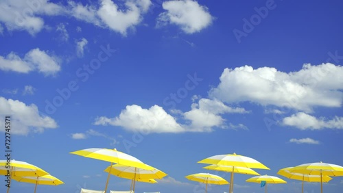 Yellow umbrellas on blue sky. 4k hdr stock footage photo