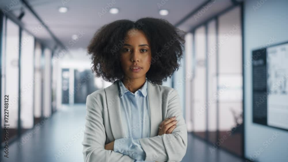Stylish Black Girl with Afro Hair, Nose Piercing and Tattoos Posing in a Modern Office Hallway. Beautiful African American Employee Looking at Camera. Young Professional on a Career Path to Success Stylish Black Girl with Afro Hair, Nose Piercing and Tattoos Posing in a Modern Office Hallway. Beautiful African American Employee Looking at Camera. Young Professional on a Career Path to Success