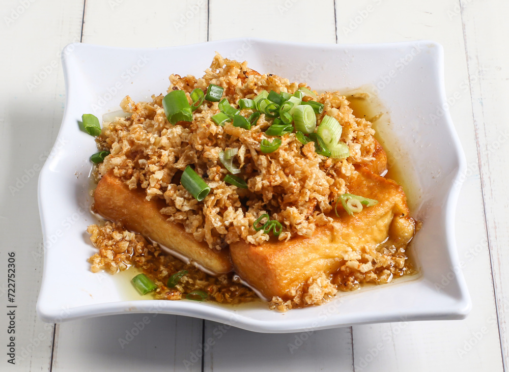 chaipoh tofu topping with spring onion served in dish isolated on table top view of singapore food chaipoh tofu topping with spring onion served in dish isolated on table top view of singapore food