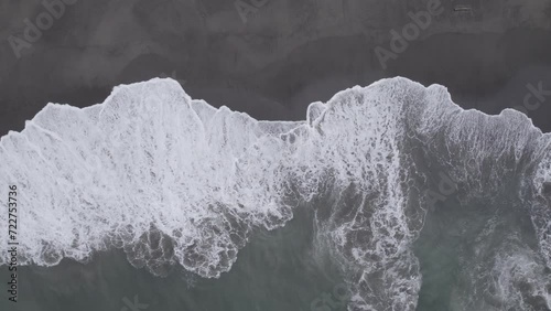 Overhead high-angle 4k aerial drone footage of ocean waves breaking on a sandy beach at Westport, Washington.