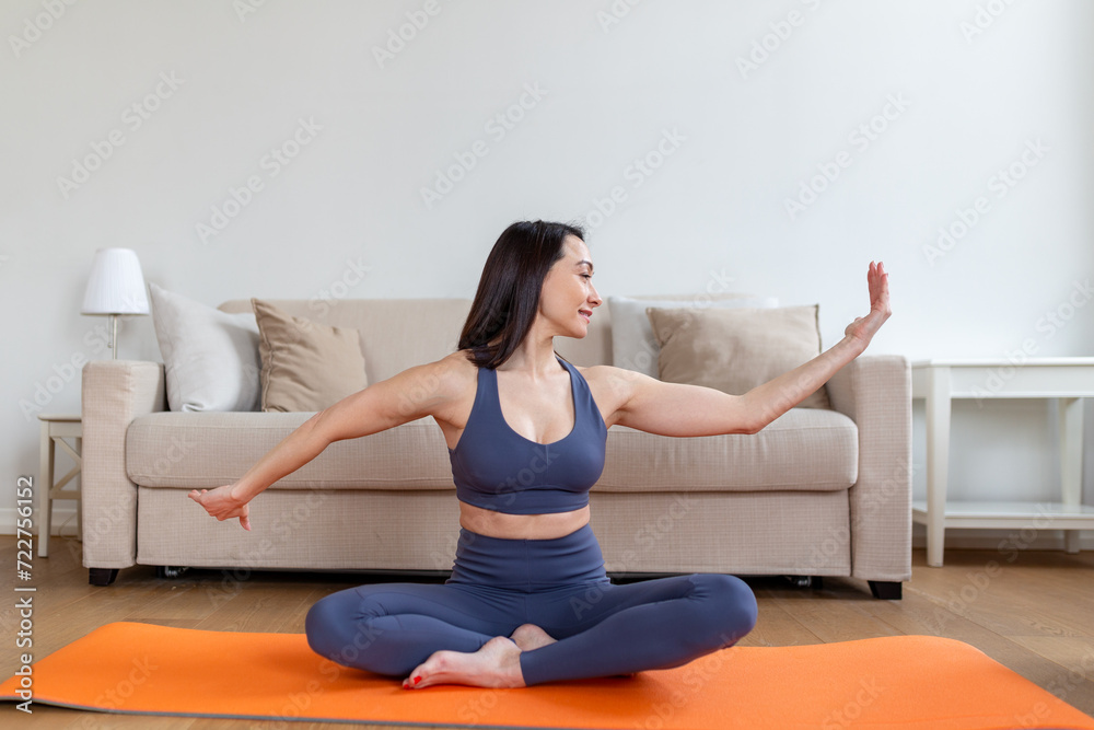 Asian woman exercising at home, stretching. Time for yoga. Attractive and healthy young woman doing exercises while resting at home. Young woman exercising at home, interior Asian woman exercising at home, stretching. Time for yoga. Attractive and healthy young woman doing exercises while resting at home. Young woman exercising at home, interior