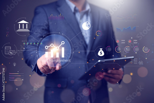Asset management concept, Businessman using tablet and touch asset management Icon  on virtual display. Financial Property Digital assets.