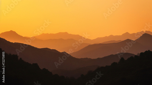 Orange sky over silhouette mountains in Montes