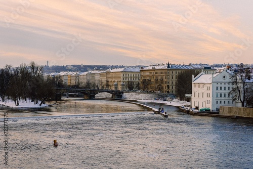 Vltava river in Prague, snowy winter, morning photo