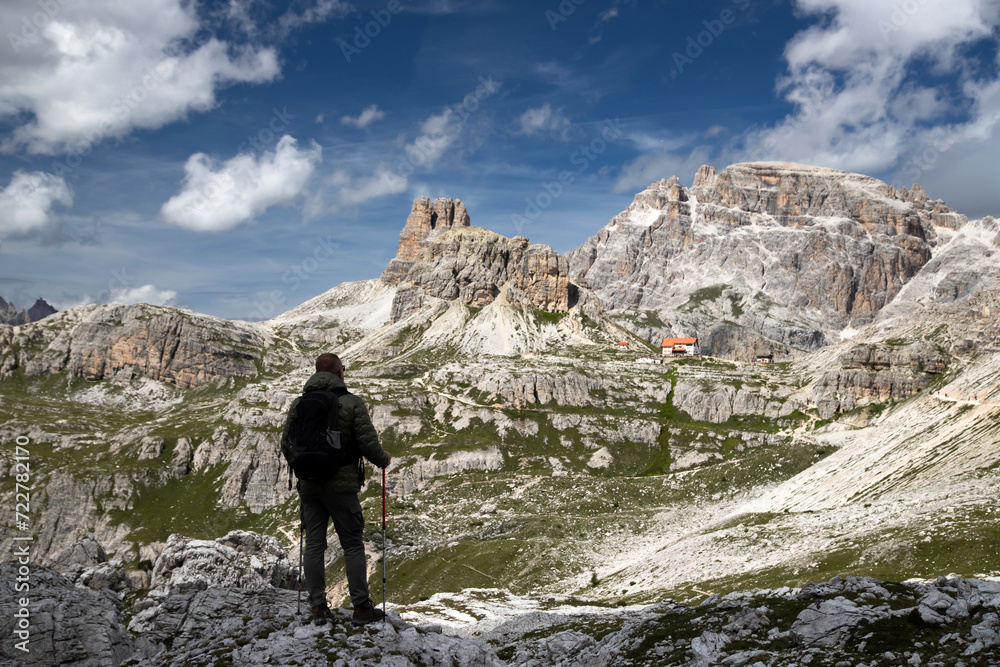 Stunning view of a tourist enjoying the view in the Tre Cime Di Lavaredo National park, Dolomites, Italy.