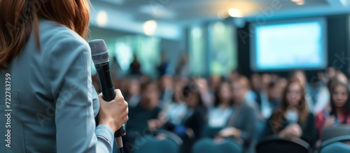 Woman speaker asking to audience in Learning Training Business conference in hall room. Generated AI